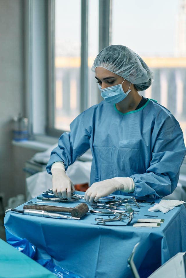 a doctor organising scalpels.