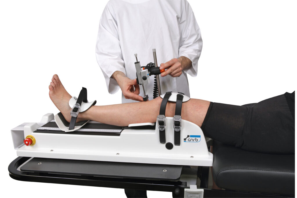 Man placing a sensor on a knee that is strapped to GNRB Arthrometer. Hamstring Stiffness & Anterior tibial translation