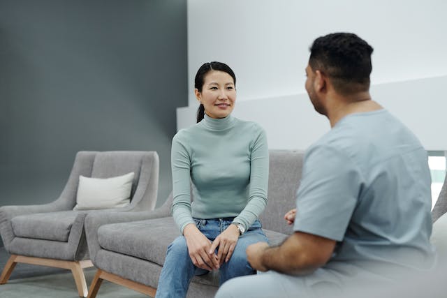 a patient sitting and talking to her doctor