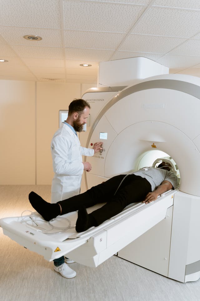 Doctors performing an MRI exam to a patient.