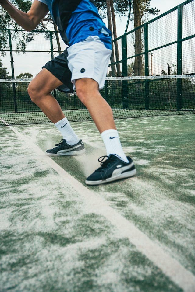 a man running on tennis court