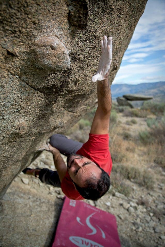 a man climbing a stone