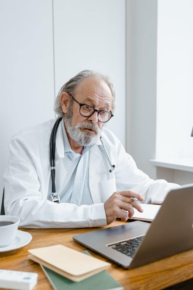 a doctor in front of the laptop
