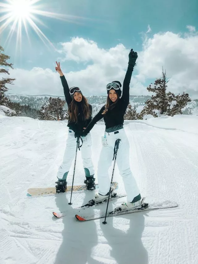 Two girls skiing and looking happy
